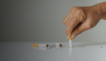 Image of a hand stubbing out a cigarette