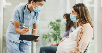 Pregnant woman consulting a nurse