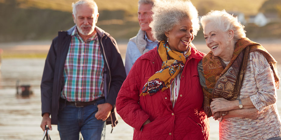 decorative stock image of seniors walking on the beach