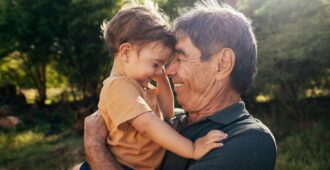 Grandfather and young boy hugging