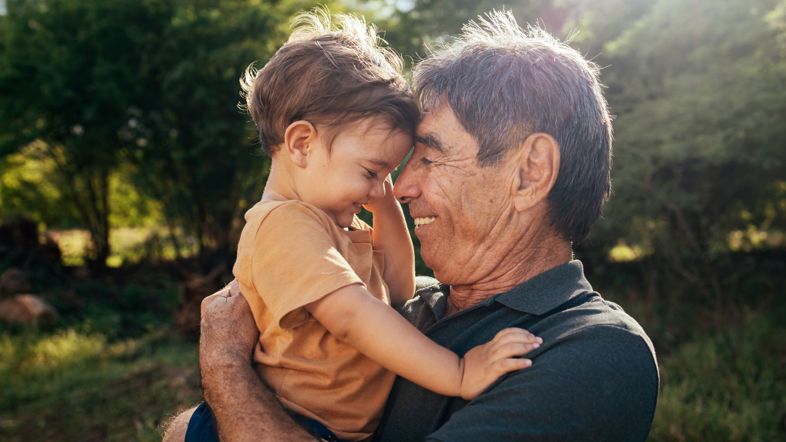 Grandfather and young boy hugging