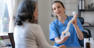 Female doctor is introducing an elderly Asian female patient about bone diseases and treatment method and medicine details.