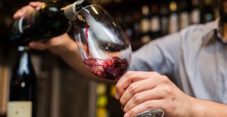 waiter pouring wine into glass