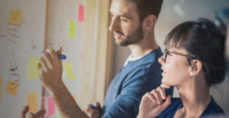 Two researchers collaborating on a project together stock image