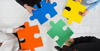 researchers putting a puzzle together to represent coproduction stock image