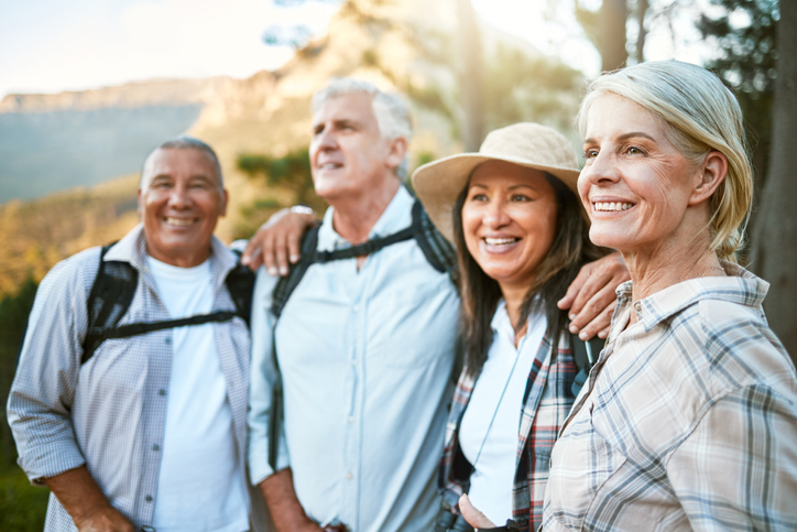 A group of senior friends on a hike enjoying the view.