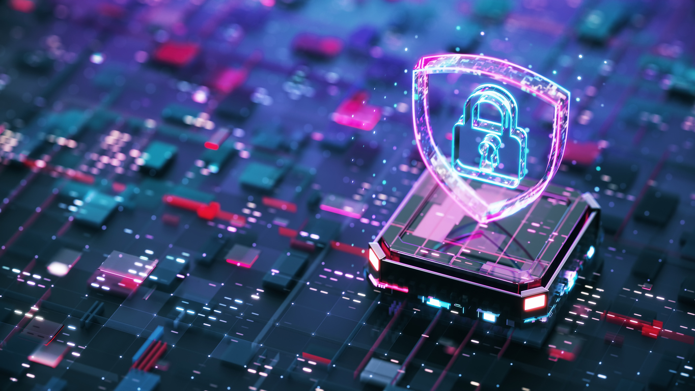 A digital illustration of a glowing shield with a padlock symbol, representing cybersecurity, sits on a futuristic circuit board background.