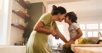 Mother and toddler son being affectionate in the kitchen