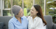 Mother with cancer and her daughter sitting together