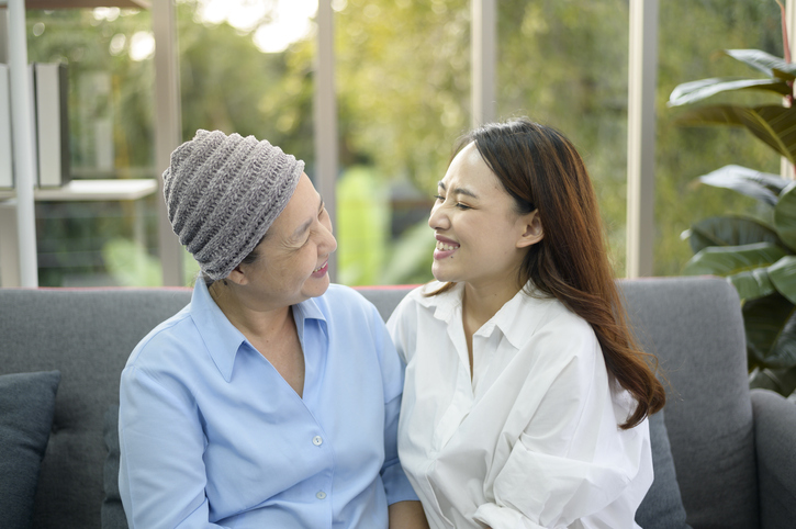 Mother with cancer and her daughter sitting together