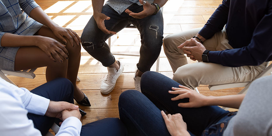 Diverse-people-during-psychological-rehab-session-sitting-indoors