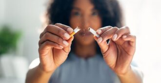 Woman breaking down cigarette to pieces